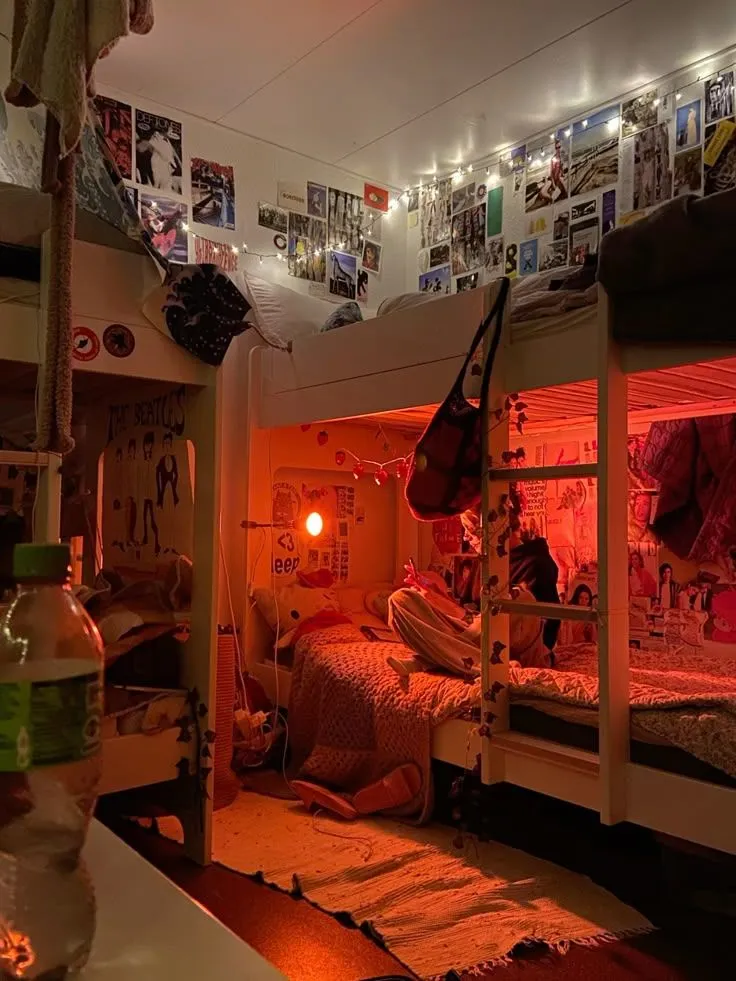 A room filled with lots of bunk beds and pictures on the wall.