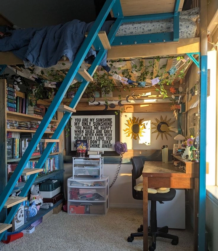 A room with a desk, chair, bookshelf and a ladder.