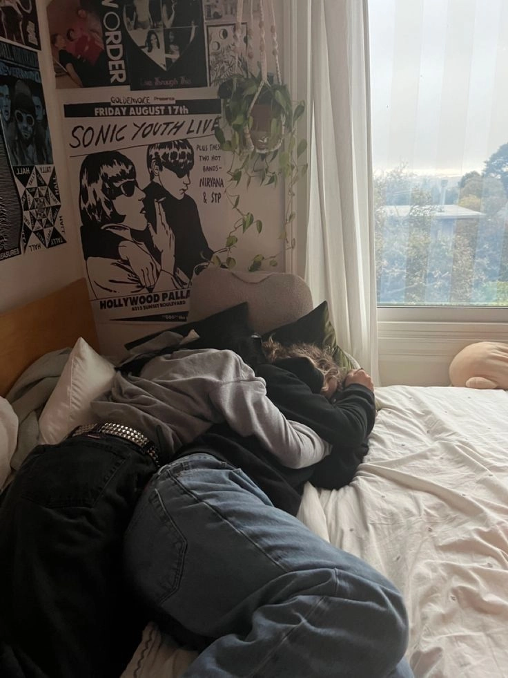 A group of people laying on top of a bed.