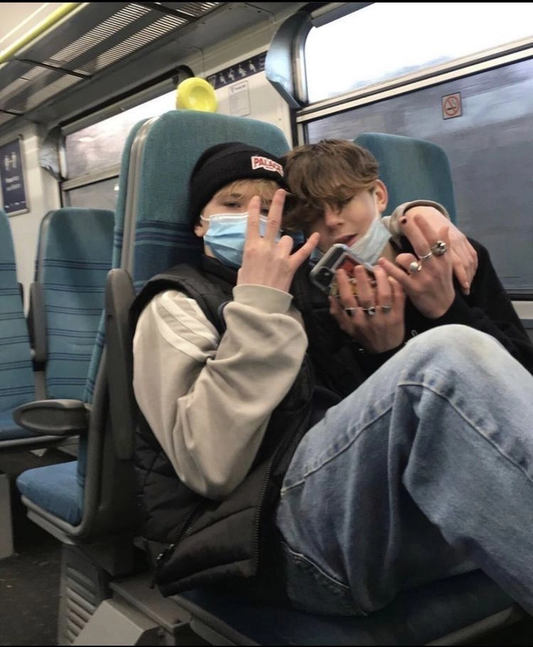 A couple of people sitting on top of a bus.