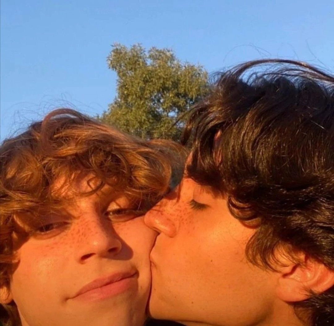 A couple of people that are kissing each other.