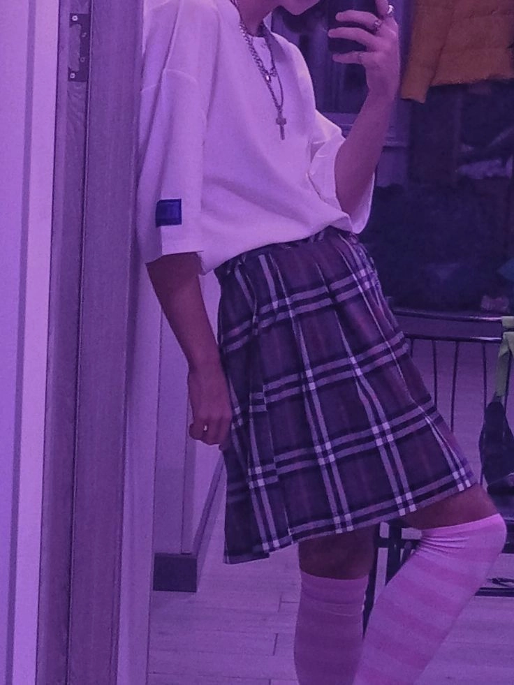 A woman taking a selfie in front of a mirror.
