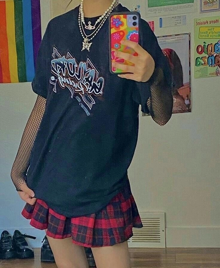 A woman taking a selfie in front of a mirror.