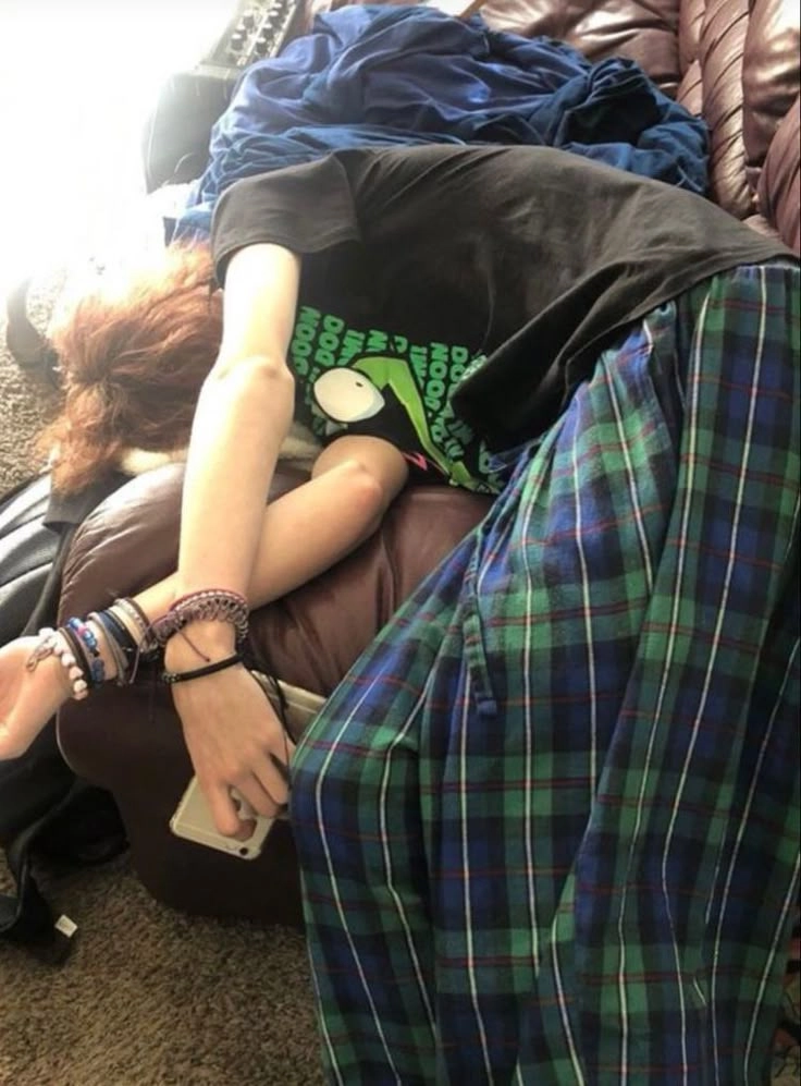 A group of people laying on top of a couch.