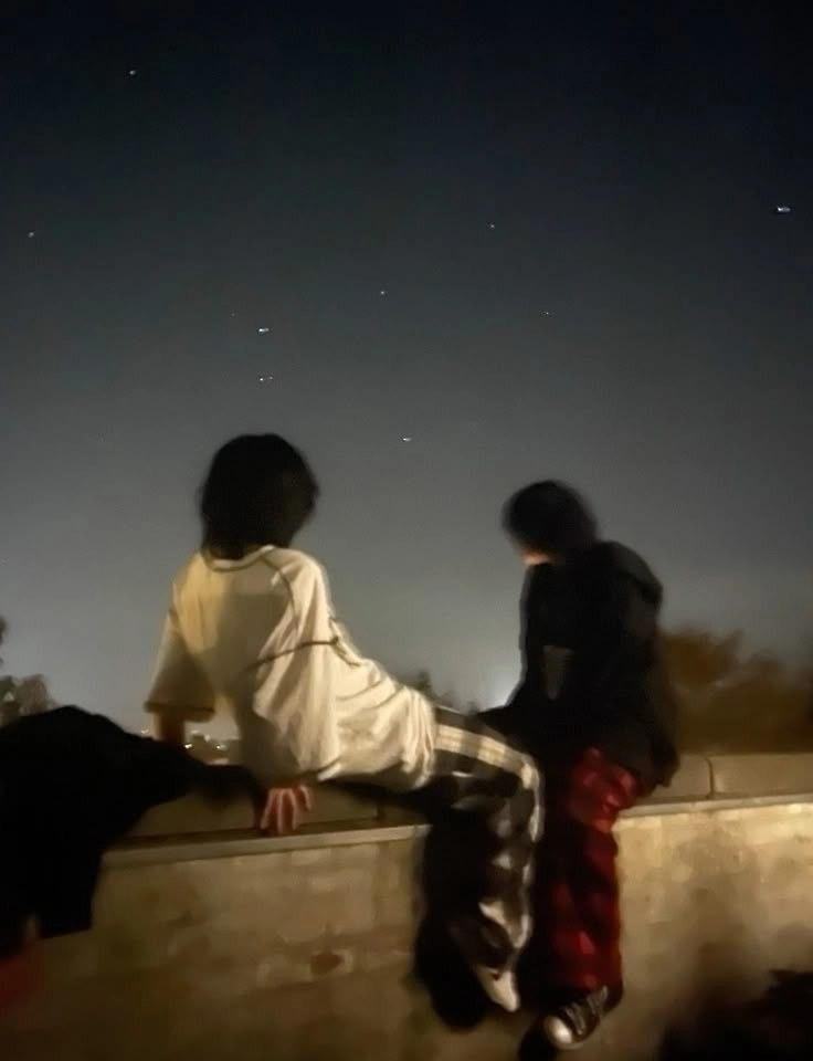 A group of people sitting on top of a building.