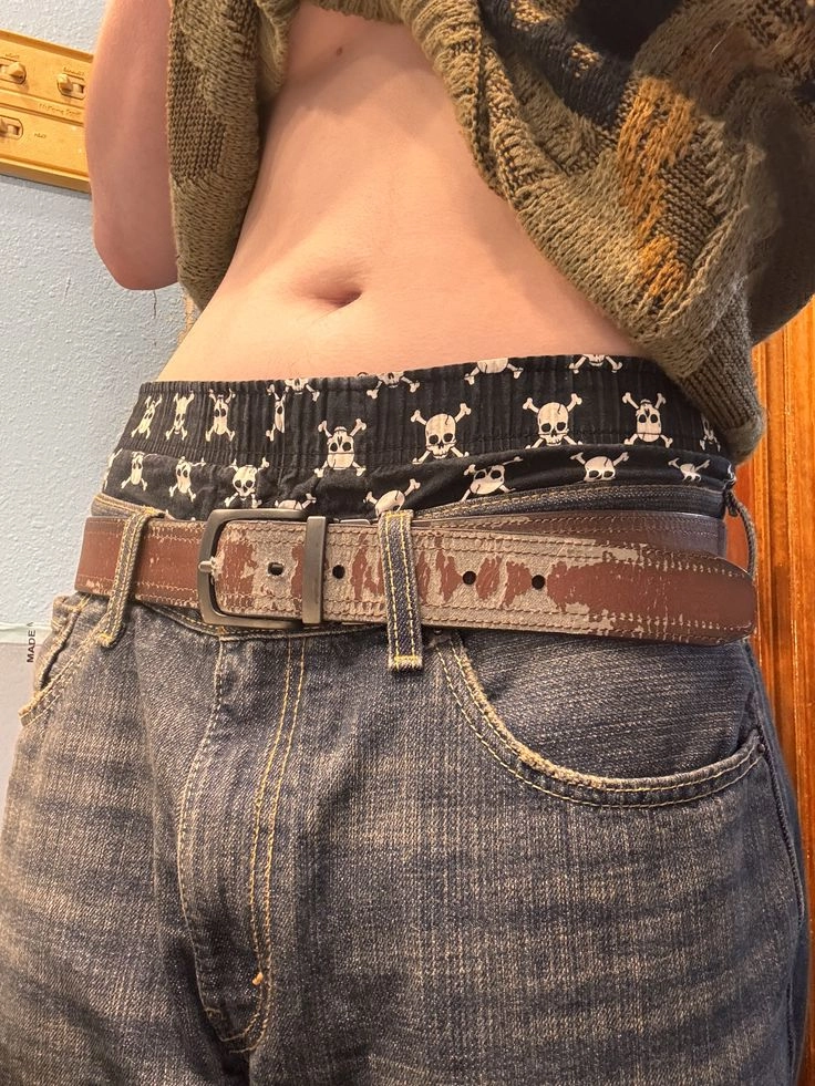 A mannequin wearing a scarf and a belt.