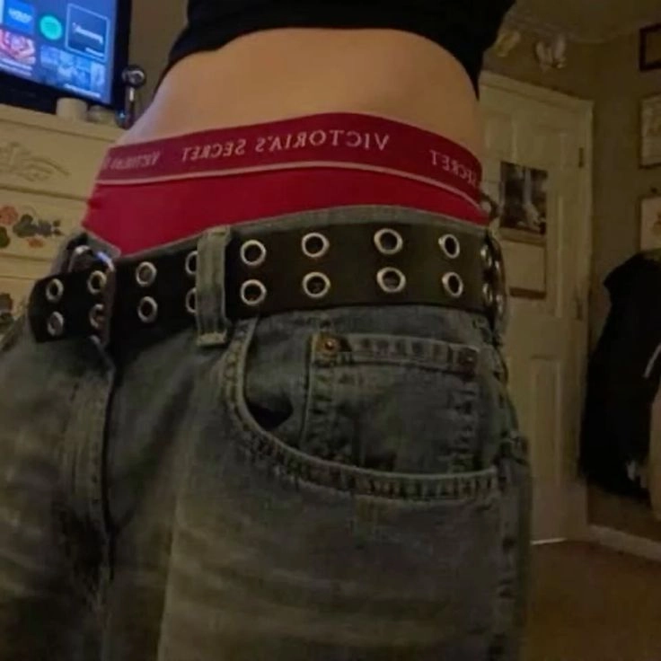 A pair of jeans with a belt on top of them.
