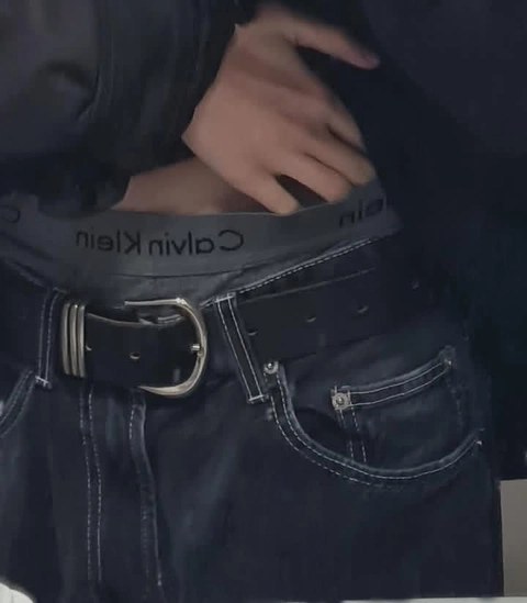 A close up of a person wearing a black shirt and jeans.
