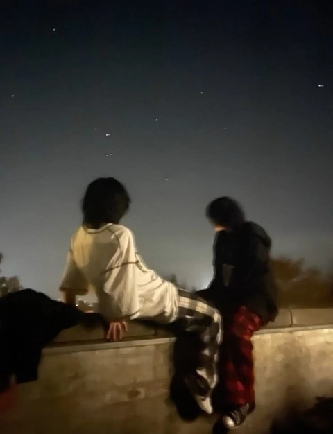 A group of people sitting on top of a building.