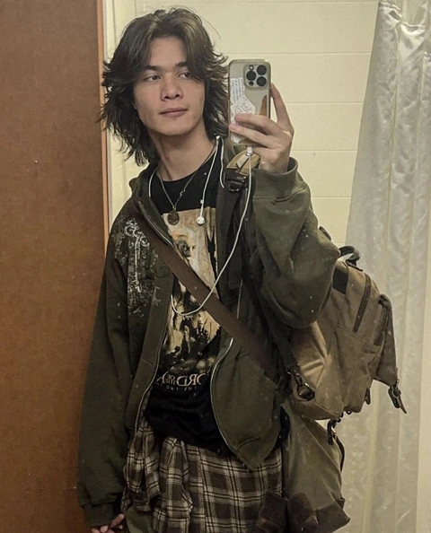 A man taking a selfie in a mirror.