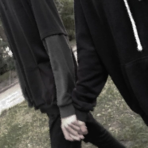 A pair of black sweatpants with white stripes on them.