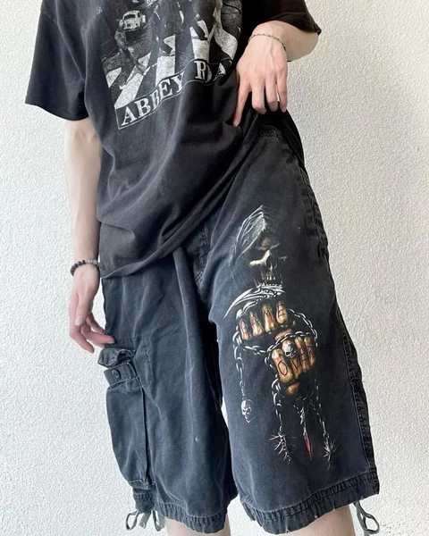 A woman wearing a black shirt and a pair of pants.