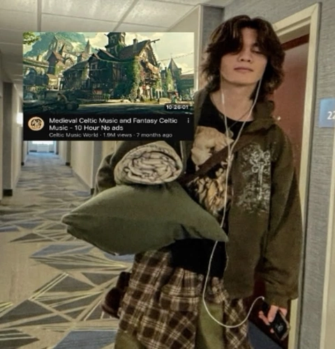 A woman holding a bunch of pillows in a hallway.