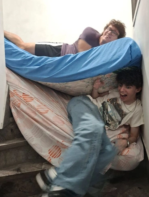 A group of people laying on top of a bed.