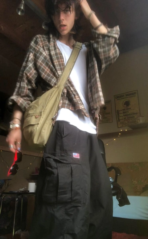A mannequin dressed as a man with a backpack.