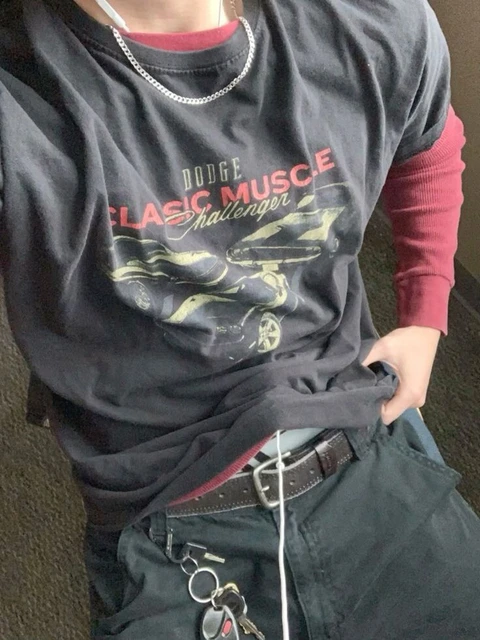 A man wearing a black shirt with a red and black design on it.