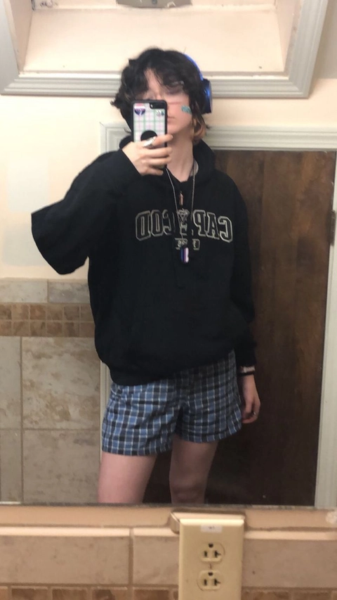 A man taking a selfie in a bathroom mirror.