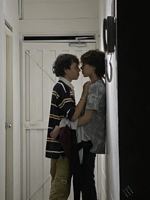 A couple of people standing next to each other in front of a door.