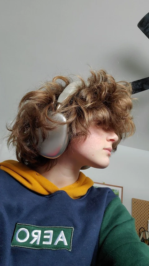 A mannequin wearing a wig and headphones.