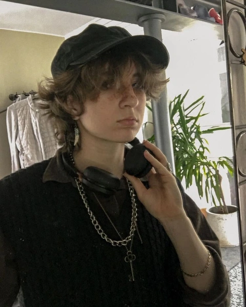 A woman in a black hat talking on a cell phone.