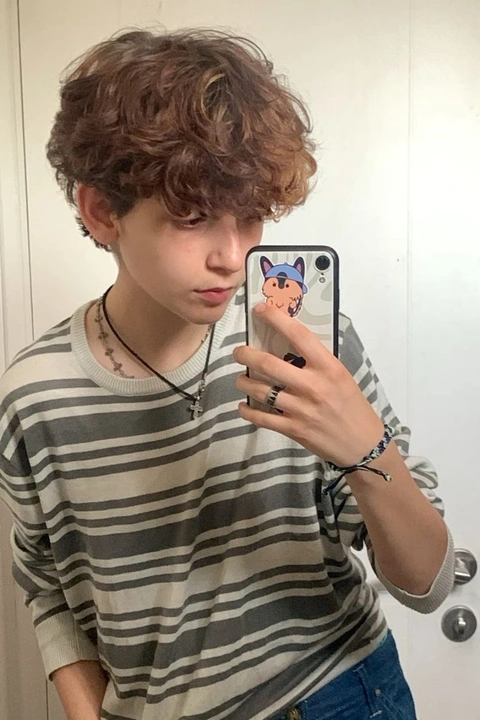 A young man taking a selfie in a mirror.