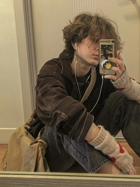 A man taking a picture of himself in a mirror.