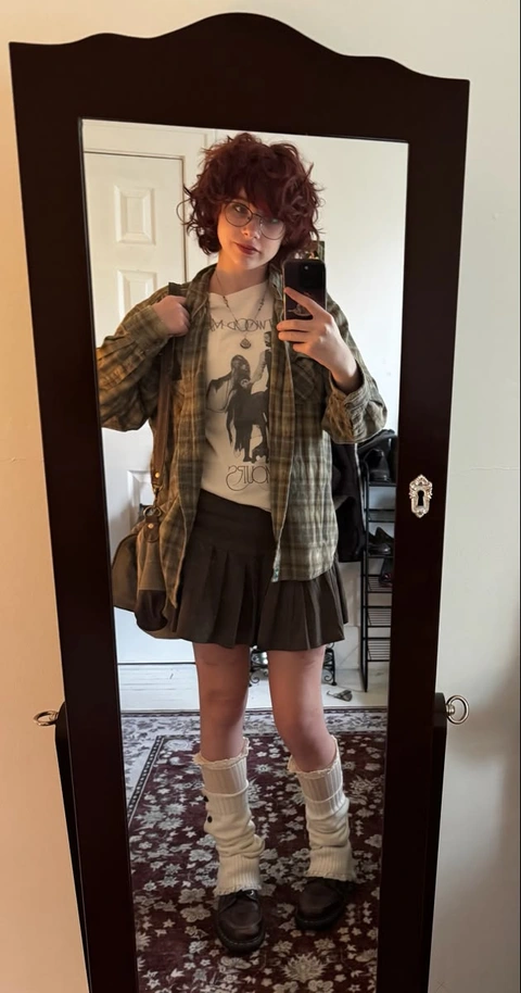 A woman taking a picture of herself in a mirror.