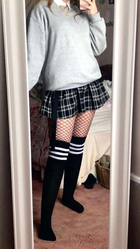 A woman taking a selfie in a mirror.