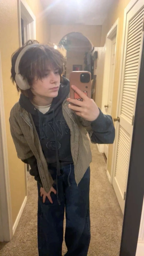 A young man taking a selfie in a mirror.