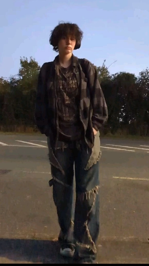 A man standing in the middle of a parking lot.