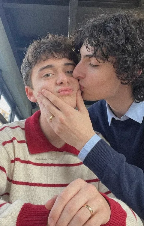 A couple of people that are kissing each other.