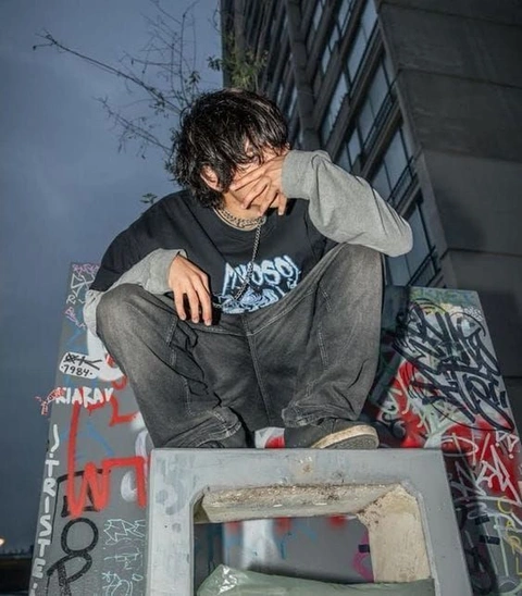 A man sitting on top of a set of stairs.