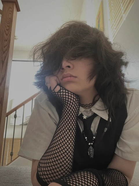 A woman with long hair sitting on a staircase.