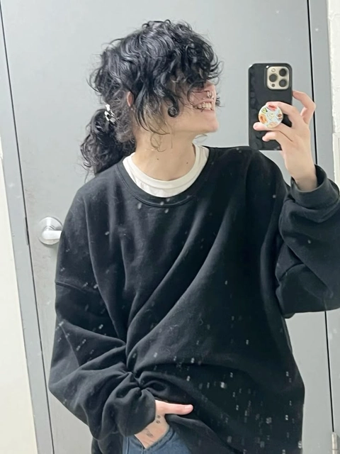 A woman taking a selfie in a mirror.