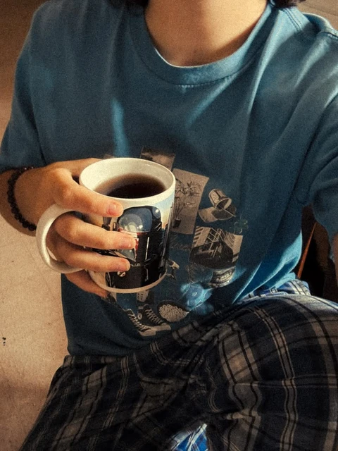 A person holding a cup of coffee in their hands.