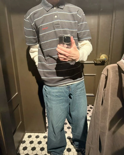 A man taking a picture of himself in a mirror.