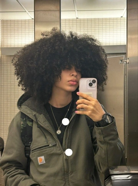 A woman taking a selfie in a mirror.