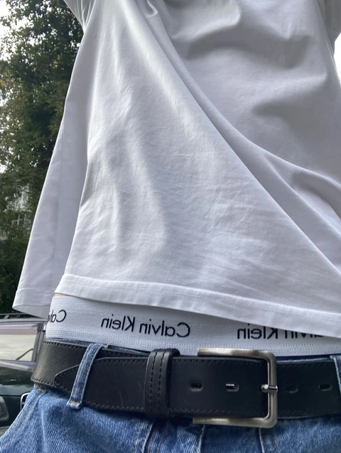 A mannequin wearing a white shirt and blue jeans.