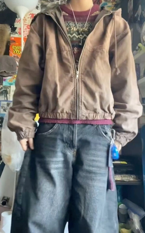 A mannequin wearing a brown jacket and jeans.