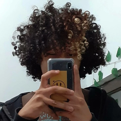 A woman taking a picture of herself with her cell phone.