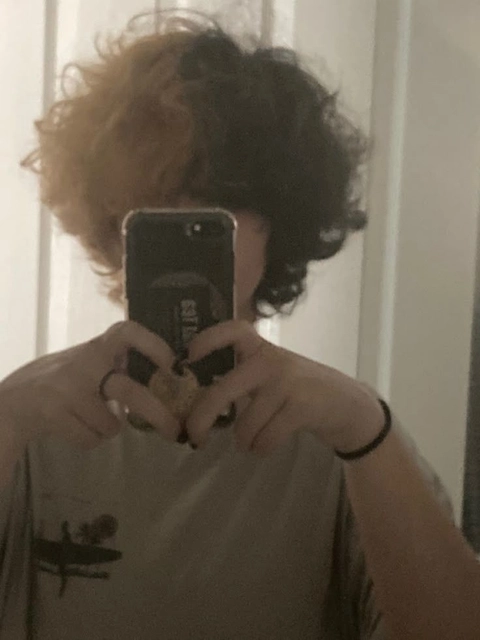 A woman taking a picture of herself in a mirror.