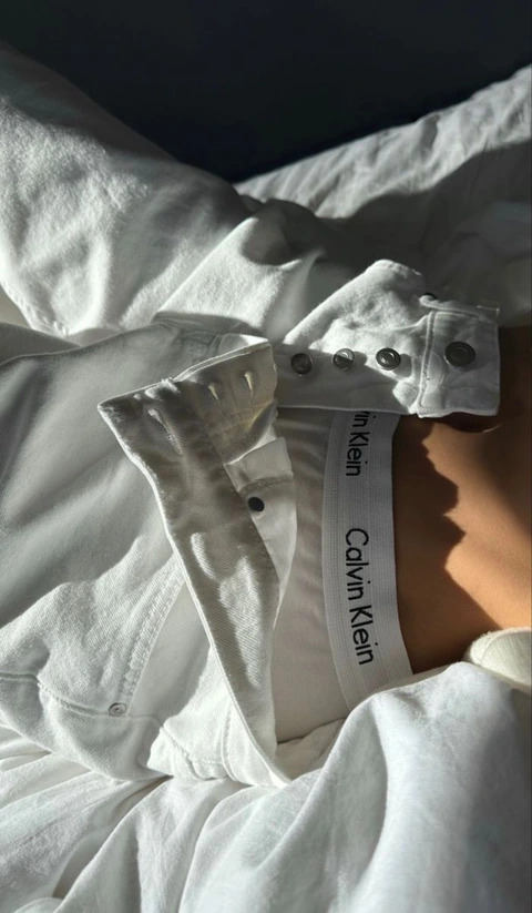 A close up of a person wearing a white shirt.