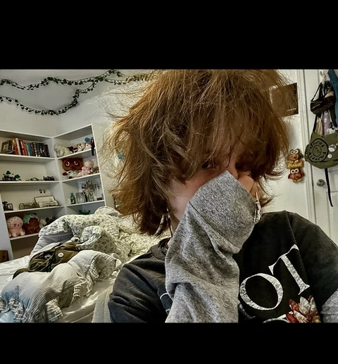 A picture of a person with long hair covering their face.