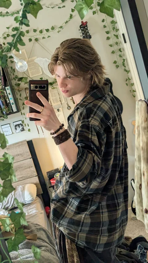 A woman taking a picture of herself in a mirror.