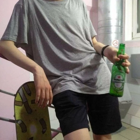 A man holding a bottle of beer in his hand.