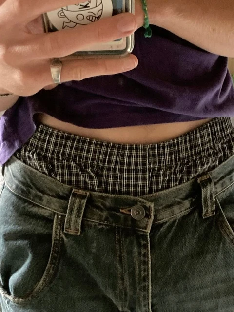 A woman taking a picture of herself with a cell phone.