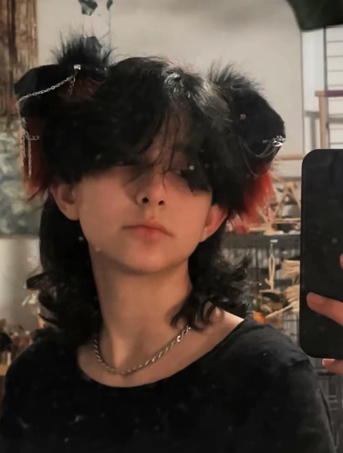 A woman with black hair is taking a selfie.
