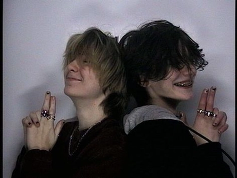 A group of three people with their hands up in the air.