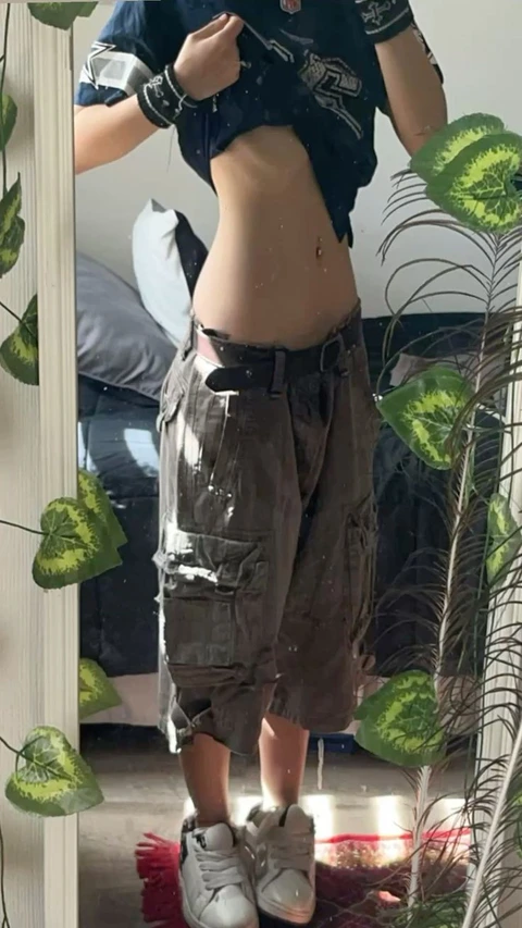 A reflection of a person standing in a mirror.