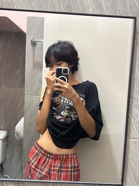 A woman taking a picture of herself in a mirror.